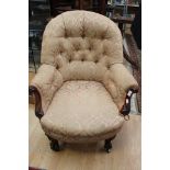 A Victorian button back easy chair, deep buttoned back,