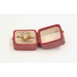 A Victorian diamond ring set to the front with four old cut diamonds, quatrefoil design,