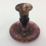 A Blue John candle holder measuring approx 7.5cm high.