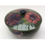 A Moorcroft, green ground, lidded bowl, 'Hibiscus' pattern, tube lined decoration,