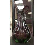 An Art Glass jug with green glass through to claret, heavily lobed ridges and acute spout,