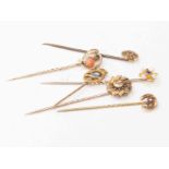 Edwardian sapphire and pearl 15ct marked stick pin with two 9ct marked stick pins,