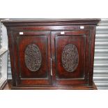 A 19th Century oak wall hanging cupboard, fitted with two doors, carved to front,