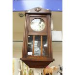 A 1930s/40s oak cased wall clock with Arabic numerals