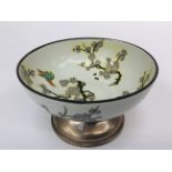 Enamelled footed bowl having Prunus flower and Bird of paradise decoration on silver foot.