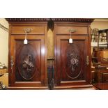 A pair of Edwardian mahogany bedside cabinets, each having a single drawer over a single door,