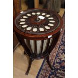 An Edwardian mahogany ladies work table, in the form of an urn, the top pierced, the sides slatted,