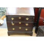 A George II oak bureau, circa 1750, the fall opening to reveal a fitted interior,