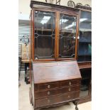 An early 20th Century mahogany bureau bookcase, glazed doors to top,