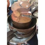 Seven copper pans, having copper covers,