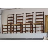 Ernest Gimson, a set of four yew wood ladderback and bobbin turned turned chairs, rush seats,