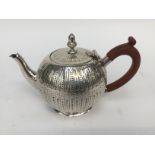 A Victorian silver tea pot, bullet shaped with chased flutes and engraved dot detail, London 1887,