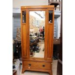 An Edwardian bedroom suite, comprising single door wardrobe, a three drawer chest,