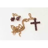 A fifteen carat yellow gold chain, suspending pinchbeck Crucifix,