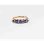 A sapphire five stone gold ring, rub over set platium and 18ct gold, centre stone approx 5.