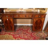 An Edwardian mahogany twin pedestal sideboard, of inverted breakfront form,