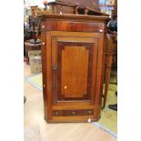 A George III oak and mahogany cross-banded hanging corner cupboard,