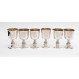 A set of six silver goblets with gilt interiors and Celtic design stems,