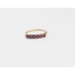 A ruby six stone ring, set in unmarked yellow metal, approx size L, approx total gross weight 1.