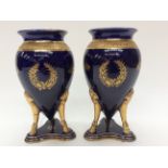 A pair of French vases; Royal blue with gilt detail, sabre legs and hoof feet.