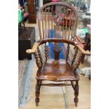 A pair of Victorian high backed Windsor chairs, each with turned rods, a central back splat,