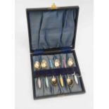 A set of six Danish, twentieth Century, silver gilt and enamel coffee spoons,