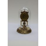 A Kundo skeleton clock under glass dome,