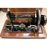 A Frister & Rossmann mahogany cased sewing machine, late Victorian, decorative gilding throughout,