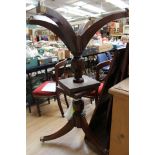 A George III mahogany triple pedestal dining table, with three leaves,