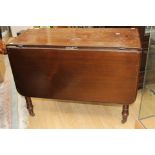 A Victorian mahogany drop leaf dining table fitted with a drawer for each side and turned legs.