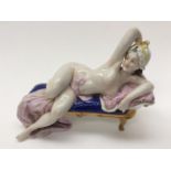 A continenatl figure of a reclining female nude