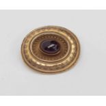 A Victorian garnet and unmarked yellow metal, large oval with scroll work,