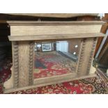 An Edwardian light oak over mantle mirror