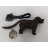 A Victorian cast iron novelty nut cracker, in the form of a dog, the tail forming the handle,