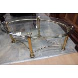 A contemporary glass topped brass coffee table,