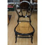 A late Victorian Aesthetic black lacquered mother of pearl inlaid bedroom chair,