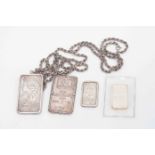 A collection of silver Ingots to include two one ounce Suisse ingots one with a rope chain,