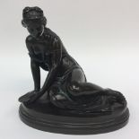 A nineteenth Century bronze figure of a reclining classical lady, holding a shell, cast,