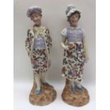 A pair of late 19th Century tinted bisque figures (2)