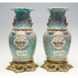 A pair of Chinese famille rose vases, mid 19th Century, turquoise ground, raised on ormolu mounts,