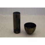 An Isle of Wight Studio Glass 'Gold on Black' range cylinder vase and matching bowl.