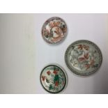 A Chinese famille verte saucer, together with an unusual glass saucer,