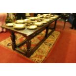 A Jacobean style oak joined long table, having a plank top, cleated ends,
