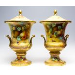 A large pair of mid 20th Century Caverswall China campana vases and covers, hand painted with fruit,