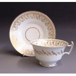 A John Rose of Coalport London shaped tea cup and saucer, decorated in white and gilt, pattern No.