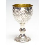 An 18th Century parcel gilt goblet, the bowl chased with scrolling flower and foliage,