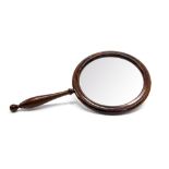 An early 20th Century oversized hand-held magnifying glass, rosewood frame with a turned handle,