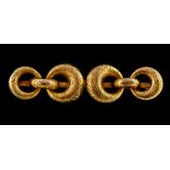 A Victorian yellow gold brooch, interlocking circular crescent design, floral and scroll patterned,