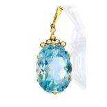 A blue topaz single stone and diamond set 18ct yellow gold pendant,