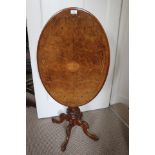 An early Victorian figured walnut and inlaid tilt top occasional table,